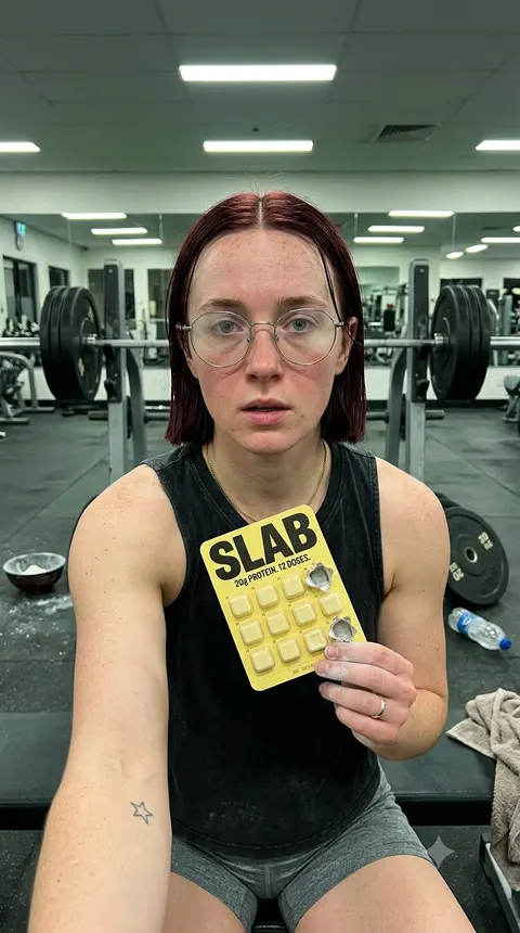 a woman at the gym eating SLAB Chocolate