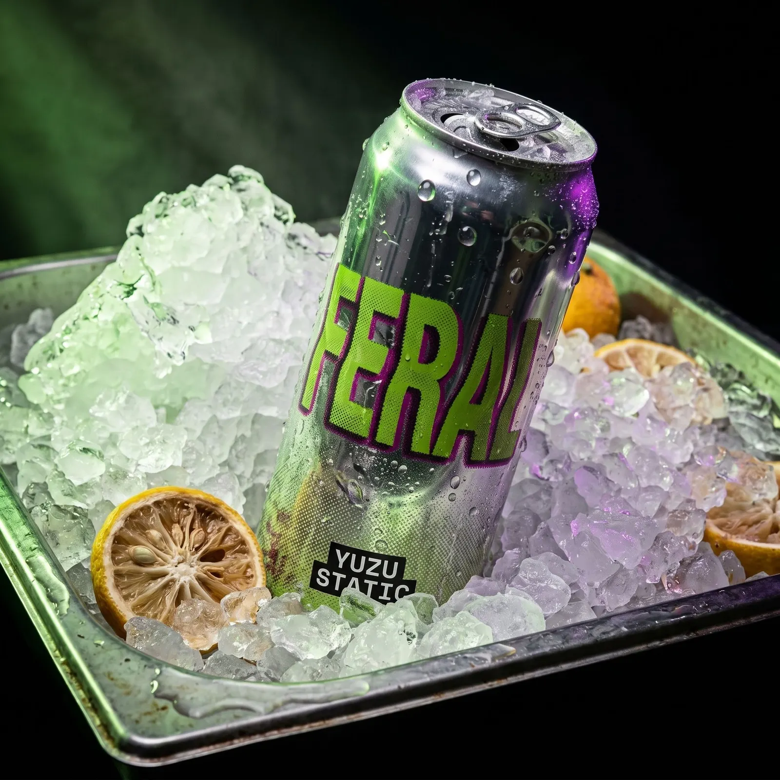 A square crop of the FERAL can in the ice tray, shot closer and lit with green light from behind.