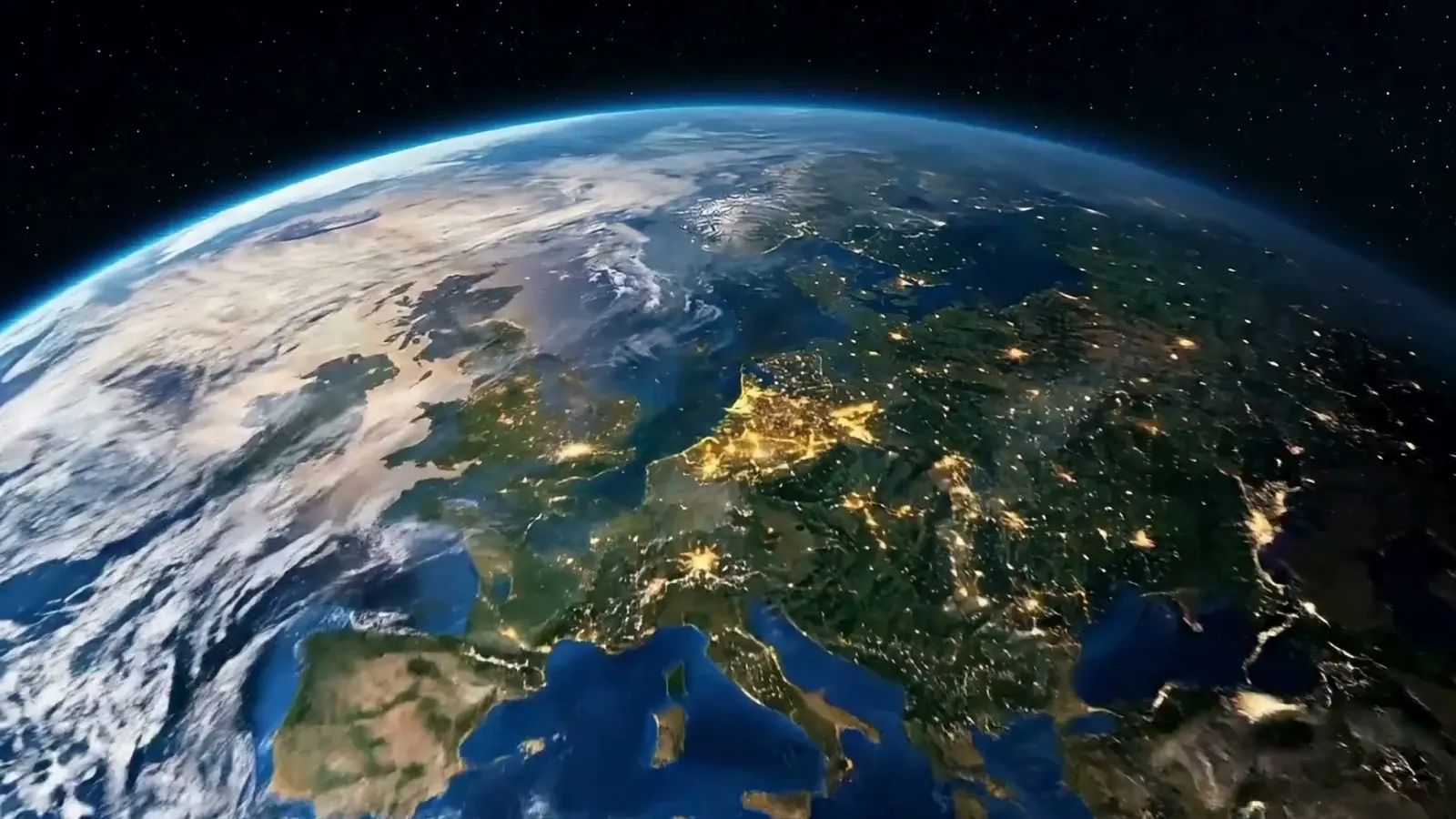 Europe at night seen from orbit, city lights picked out across the continent, the curve of the Earth against black space.